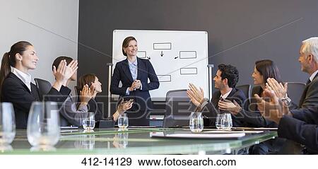 Business people applauding colleague in meeting View Large Photo Image Stock Photo - Business people applauding colleague in meeting. Fotosearch