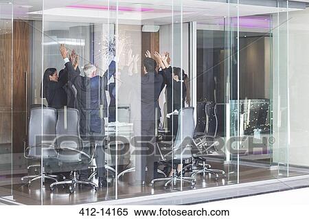 Stock Photography - Business people cheering in meeting. Fotosearch