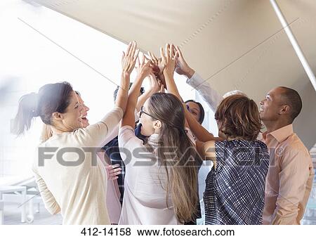 Business people cheering in office View Large Photo Image Stock Photo - Business people cheering in office. Fotosearch