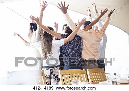 Business people cheering in office View Large Photo Image Stock Photo - Business people cheering in office. Fotosearch