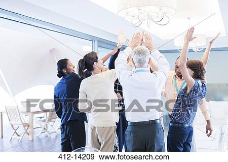 Stock Photo - Business people cheering in office. Fotosearch