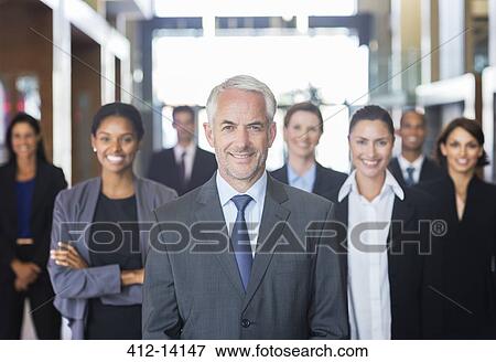 Business people smiling in lobby View Large Photo Image Stock Photo - Business people smiling in lobby. Fotosearch