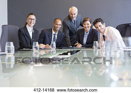 Business people smiling in meeting View Large Photo Image Stock Photo - Business people smiling in meeting. Fotosearch
