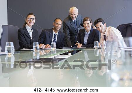 Business people smiling in meeting View Large Photo Image Stock Photography - Business people smiling in meeting. Fotosearch