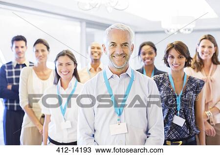 Stock Image - Business people smiling in office. Fotosearch