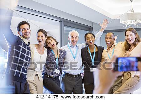Business people taking photograph together View Large Photo Image Stock Photography - Business people taking photograph together. Fotosearch