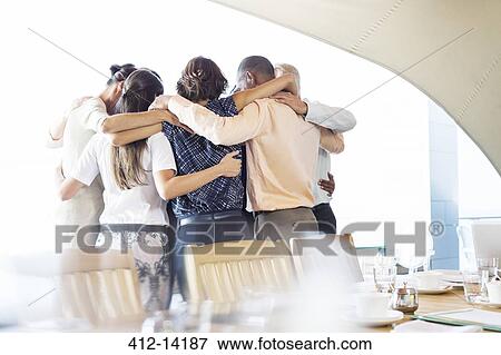 Business people talking in huddle View Large Photo Image Stock Photo - Business people talking in huddle. Fotosearch