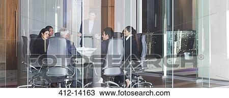 Stock Image - Business people talking in meeting. Fotosearch
