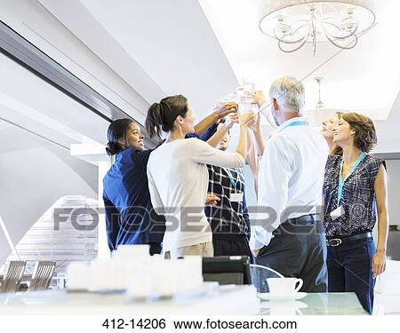 Stock Photograph - Business people toasting water glasses. Fotosearch