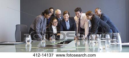 Business people using laptop in meeting View Large Photo Image Stock Photo - Business people using laptop in meeting. Fotosearch