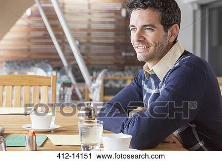 Stock Image - Businessman smiling in meeting. Fotosearch