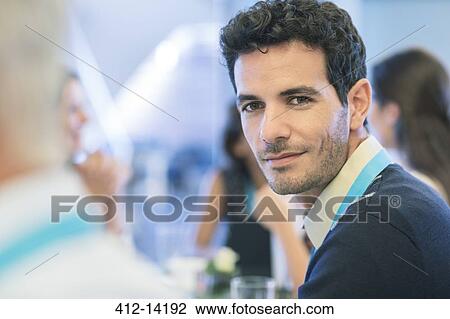 Businessman smiling in meeting View Large Photo Image Stock Image - Businessman smiling in meeting. Fotosearch
