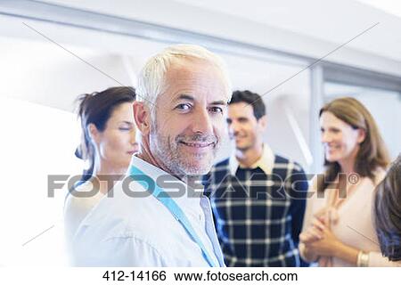 Businessman smiling in meeting View Large Photo Image Stock Photograph - Businessman smiling in meeting. Fotosearch