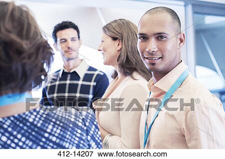 Stock Photo - Businessman smiling in office. Fotosearch