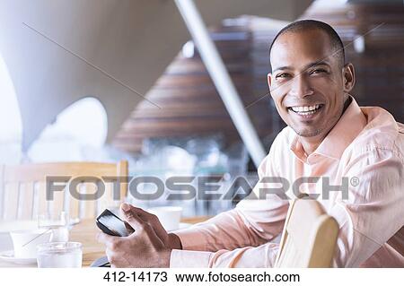 Businessman using cell phone in office View Large Photo Image Stock Image - Businessman using cell phone in office. Fotosearch