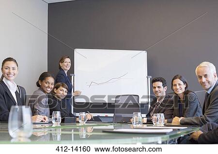 Businesswoman drawing graph for colleagues in meeting View Large Photo Image Stock Image - Businesswoman drawing graph for colleagues in meeting. Fotosearch