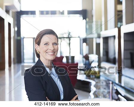 Businesswoman smiling in lobby View Large Photo Image Stock Photo - Businesswoman smiling in lobby. Fotosearch