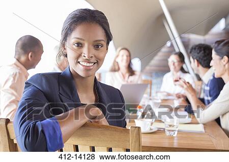 Stock Photo - Businesswoman smiling in meeting. Fotosearch