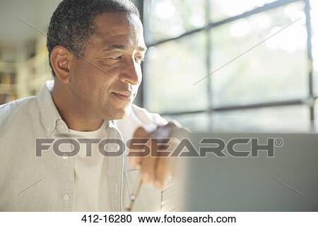 Stock Image - Close up of senior man at laptop. Fotosearch