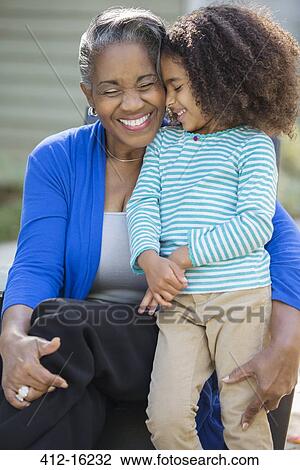 Stock Image - Close up of smiling grandmother and granddaughter. Fotosearch