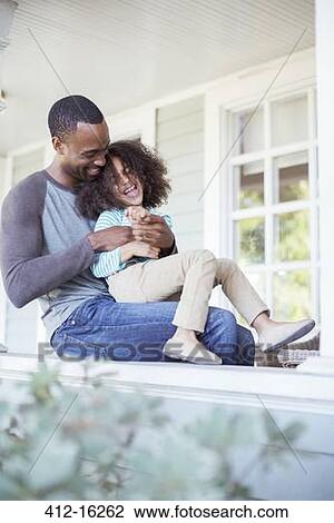 Father tickling daughter on porch View Large Photo Image Stock Image - Father tickling daughter on porch. Fotosearch