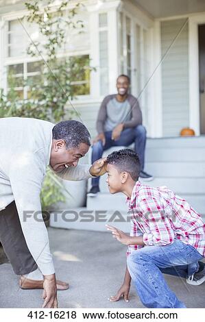 Grandfather and grandson practicing football stance View Large Photo Image Stock Photo - Grandfather and grandson practicing football stance. Fotosearch