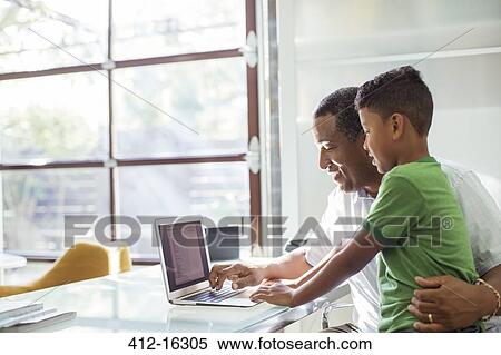 Grandfather and grandson using laptop View Large Photo Image Stock Photography - Grandfather and grandson using laptop. Fotosearch
