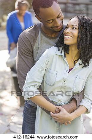Happy couple hugging outdoors View Large Photo Image Picture - Happy couple hugging outdoors. Fotosearch