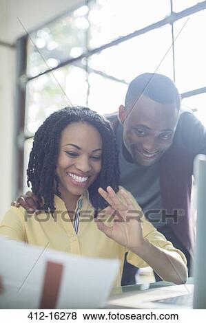Happy couple paying bills at laptop View Large Photo Image Stock Photo - Happy couple paying bills at laptop. Fotosearch