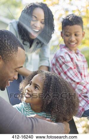 Stock Image - Happy family outdoors. Fotosearch