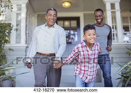 Multi-generation men holding hands outside house View Large Photo Image Stock Image - Multi-generation men holding hands outside house. Fotosearch