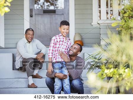 Stock Photography - Multi-generation men on porch steps. Fotosearch