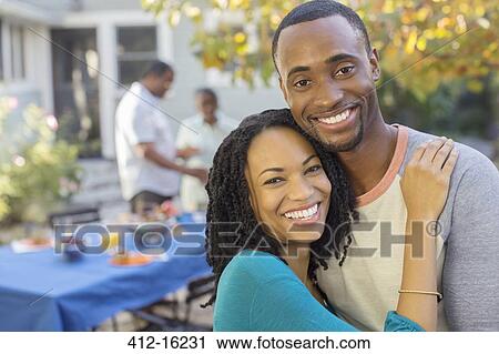 Portrait of happy couple near patio table View Large Photo Image Stock Image - Portrait of happy couple near patio table. Fotosearch