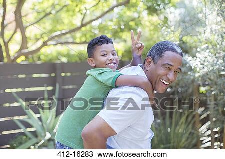 Portrait of happy grandfather piggybacking grandson View Large Photo Image Stock Image - Portrait of happy grandfather piggybacking grandson. Fotosearch