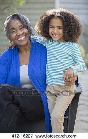 Stock Photo - Portrait of happy grandmother and granddaughter outdoors. Fotosearch