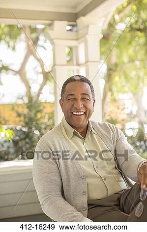 Portrait of laughing senior man on porch View Large Photo Image Stock Photo - Portrait of laughing senior man on porch. Fotosearch