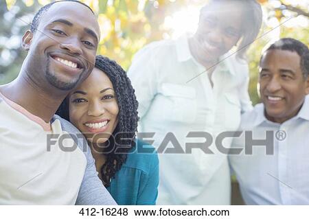 Portrait of smiling couple with parents View Large Photo Image Stock Photo - Portrait of smiling couple with parents. Fotosearch