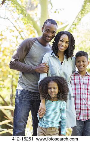 Stock Image - Portrait of smiling family outdoors. Fotosearch