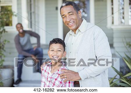 Portrait of smiling grandfather and grandson outside house View Large Photo Image Stock Image - Portrait of smiling grandfather and grandson outside house. Fotosearch