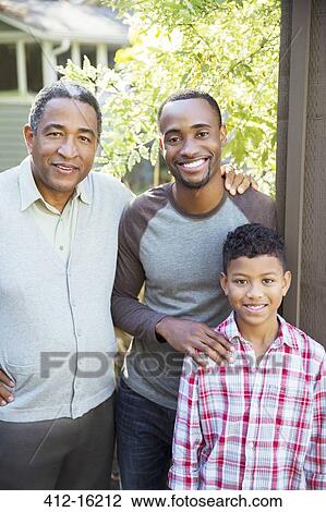 Stock Image - Portrait of smiling multi-generation men outdoors. Fotosearch