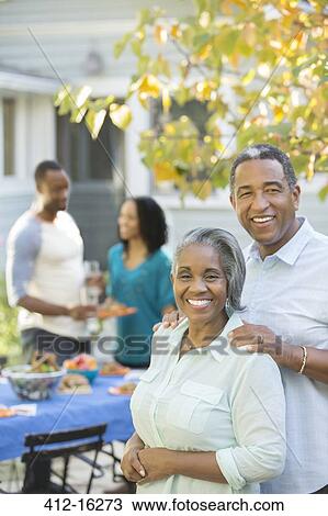Portrait of smiling senior couple at barbecue View Large Photo Image Stock Image - Portrait of smiling senior couple at barbecue. Fotosearch