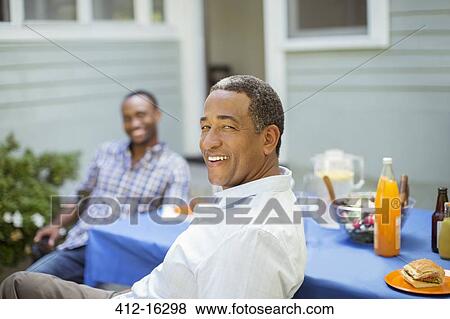 Portrait of smiling senior man at barbecue View Large Photo Image Stock Photo - Portrait of smiling senior man at barbecue. Fotosearch