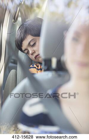 Boy sleeping in back seat of car View Large Photo Image Stock Photo - Boy sleeping in back seat of car. Fotosearch
