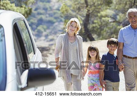 Grandparents and grandchildren holding hands outside car View Large Photo Image Stock Image - Grandparents and grandchildren holding hands outside car. Fotosearch