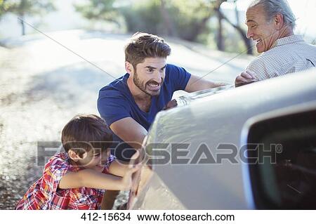 Multi-generation men pushing car at roadside View Large Photo Image Picture - Multi-generation men pushing car at roadside. Fotosearch
