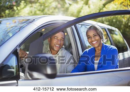 Portrait of happy couple inside and outside of car View Large Photo Image Stock Image - Portrait of happy couple inside and outside of car. Fotosearch