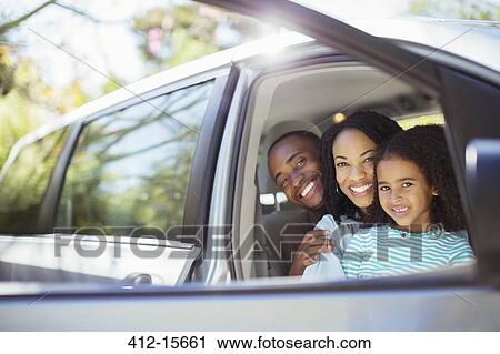 Portrait of happy family inside car View Large Photo Image Stock Image - Portrait of happy family inside car. Fotosearch