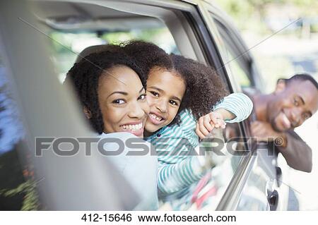 Portrait of happy family leaning out car windows View Large Photo Image Stock Photograph - Portrait of happy family leaning out car windows. Fotosearch