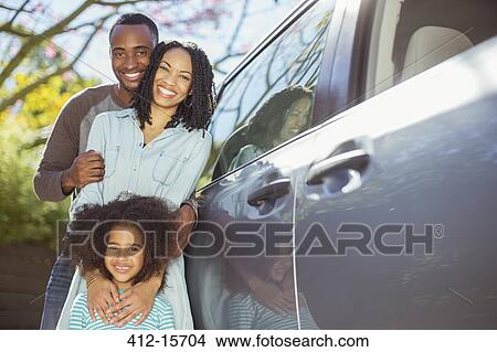 Portrait of happy family outside car View Large Photo Image Picture - Portrait of happy family outside car. Fotosearch