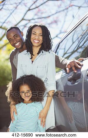 Portrait of happy family outside car View Large Photo Image Stock Image - Portrait of happy family outside car. Fotosearch